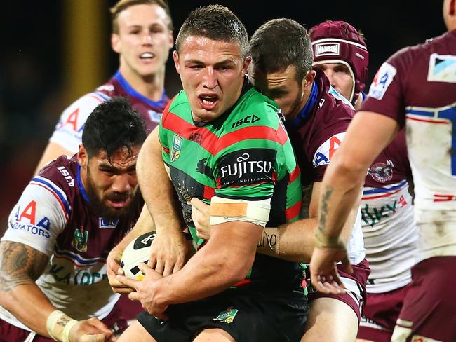 SYDNEY, AUSTRALIA - AUGUST 08: Sam Burgess of the Rabbitohs is tackled during the round 22 AFL match between the South Sydney Rabbitohs and the Manly Sea Eagles at Sydney Cricket Ground on August 8, 2014 in Sydney, Australia. (Photo by Mark Nolan/Getty Images)