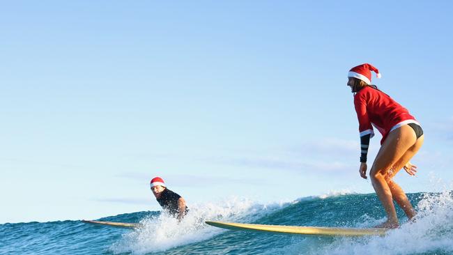 Santas surf at Currumbin Alley. Photo: Luke Workman/@photo_13_ /Instagram