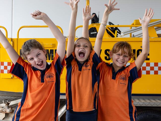 Elsie Burton (Year 5), Darcee Mclachlan (Year 4) and Kaylee Mcgrady (Year 5) as Girraween Primary School students tour the NTES Palmerston Volunteer Unit, meeting Paddy the Platypus and testing out the emergency sirens. Picture: Pema Tamang Pakhrin