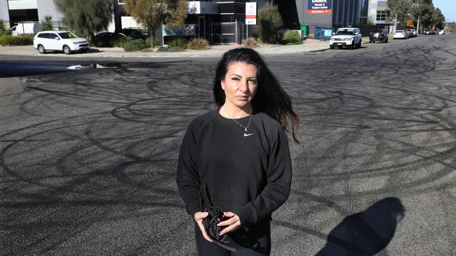 Keilor Park business owner Romina Disauro with the remains of car tyres where a gathering of hoon drivers gathered last night. Picture: David Crosling