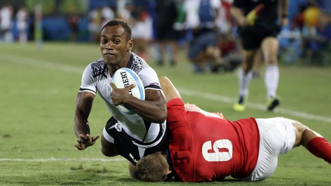 Fiji’s Osea Kolinisau scores a try as Britain’s Tom Mitchell defends.