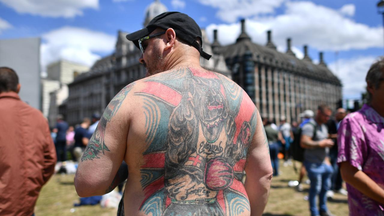 Members of a far-right group stands guard over statues in parliament Square. Picture: Ben Stansall/AFP