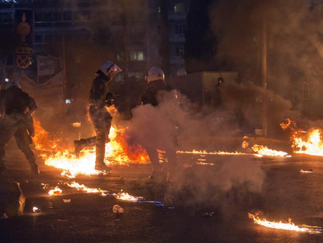 Riot police officers survey the damage<b>.</b>