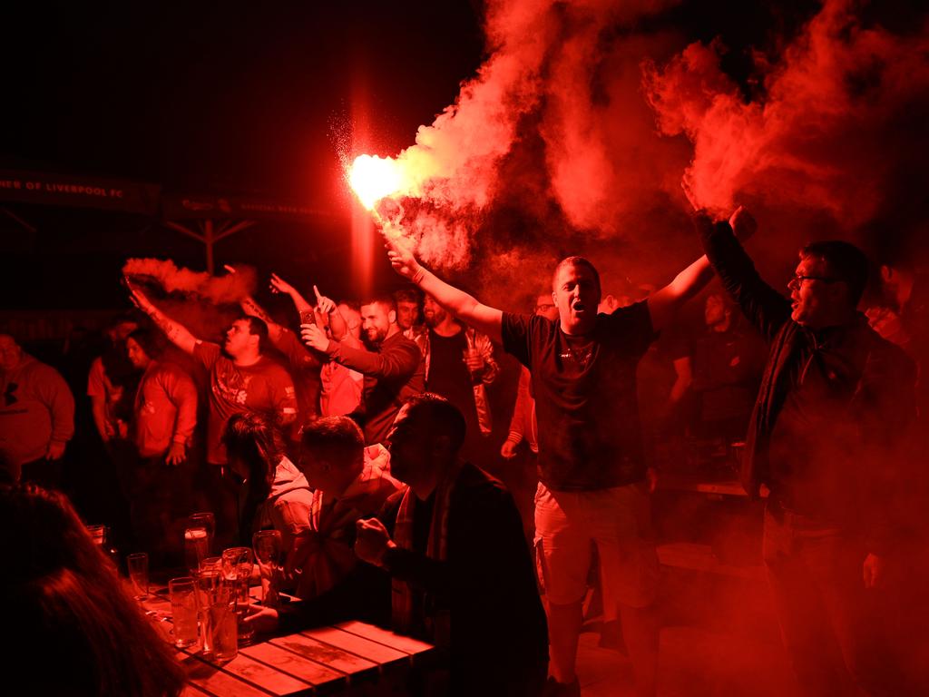 Liverpool fans celebrate the only way they know how. (Photo by Oli SCARFF / AFP)