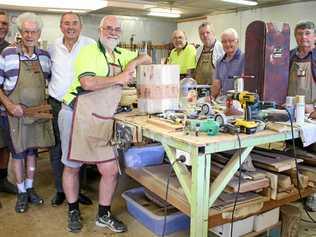 WELCOME RELIEF: Chris Gulaptis with members of the U3A Men's Shed in their workshop. Picture: Debbie Newton