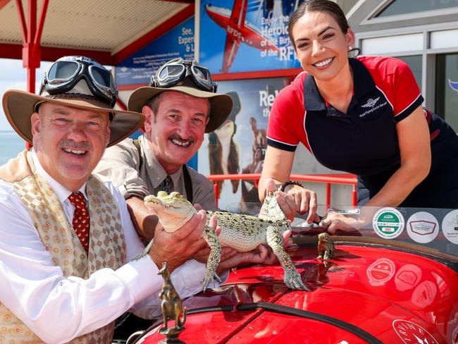 Birtles and the Bean in Darwin, NT at the Royal Flying Doctor Museum. Matthew Benns and Warren Brown, having arrived in Australia with their globetrotting car, with RFDS tourism manager (NT) Bek Garrett and Snowflake the baby saltwater crocodile. Photo: Nigel Wright