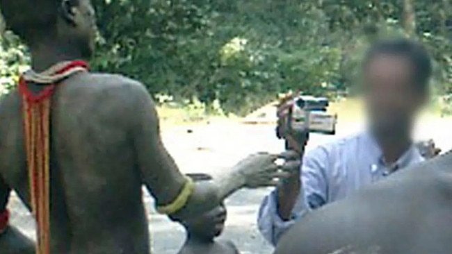 A tourist pictured here filming Jarawa tribespeople. Any interaction with the tribe carries a seven-year jail sentence. Picture: Supplied