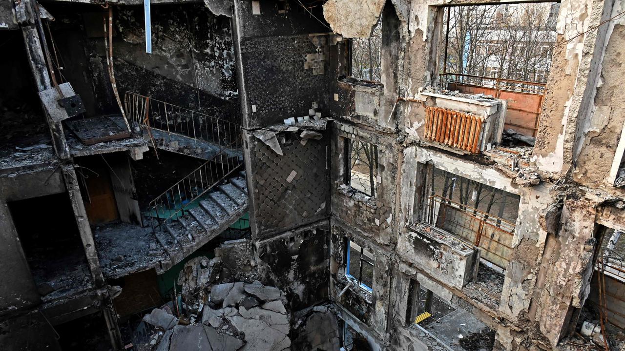 This photograph shows a partially destroyed five storey residential building in the Ukrainian city of Kharkiv. (Photo by SERGEY BOBOK / AFP)