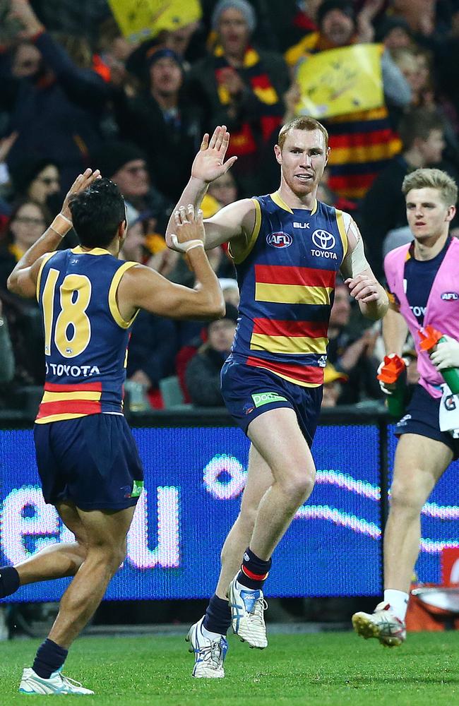 Lynch celebrates a goal with Eddie Betts. Photo: Sarah Reed.