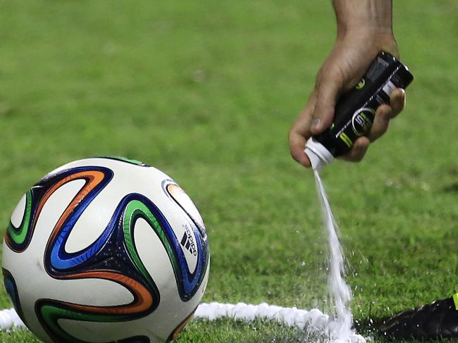 In this June 6, 2014, photo, a referee uses vanishing spray during a referee's training session in Rio de Janeiro, Brazil. Referees will use vanishing spray during 2014 World Cup to stop defensive walls creeping forward at free-kicks. The international soccer tournament is set to begin in a few days, with Brazil and Croatia competing in the opening match on June 12. (AP Photo/Hassan Ammar)