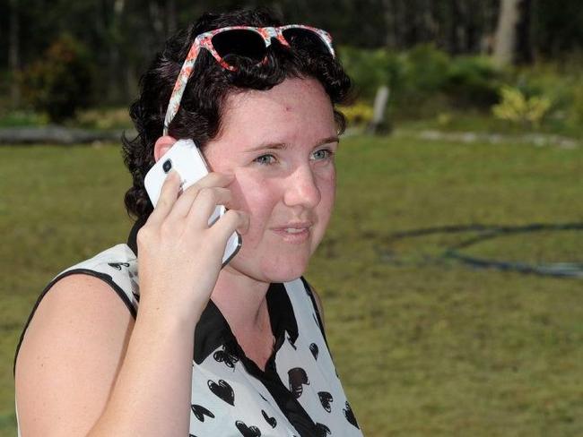 Nikki Lamb stands in the front yard to find reception for her phone after a 000 call cut in and out during her father-in-law's medical emergency on Monday. Picture: Valerie Horton