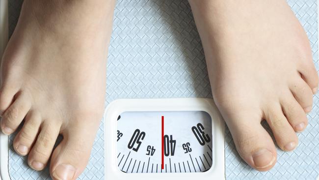 Feet on weighing scales. Weight loss. Dieting. Generic image.