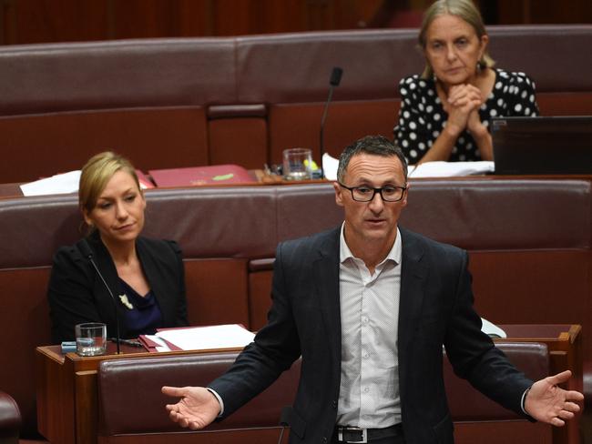 Look at those long faces … Greens leader Senator Richard Di Natale speaks on an amendment to the government's senate electoral reforms. Pictures: AAP Image/Mick Tsikas