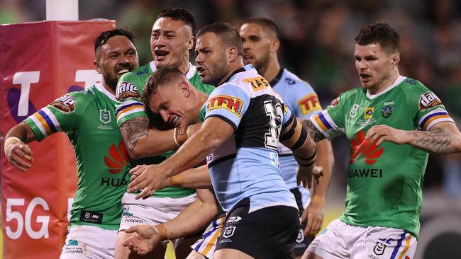 Match hero Jack Wighton of the Canberra Raiders, head shown in centre, celebrates after scoring a try as Wade Graham of the Cronulla Sharks gestures to the referee during the NRL elimination final match on Saturday. Picture: Mark Kolbe/Getty Images