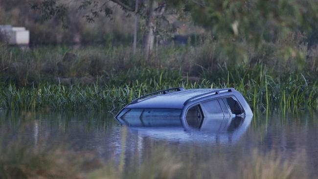 The scene where a car drove into a lake killing three children in Wyndham Vale. Picture: Hamish Blair