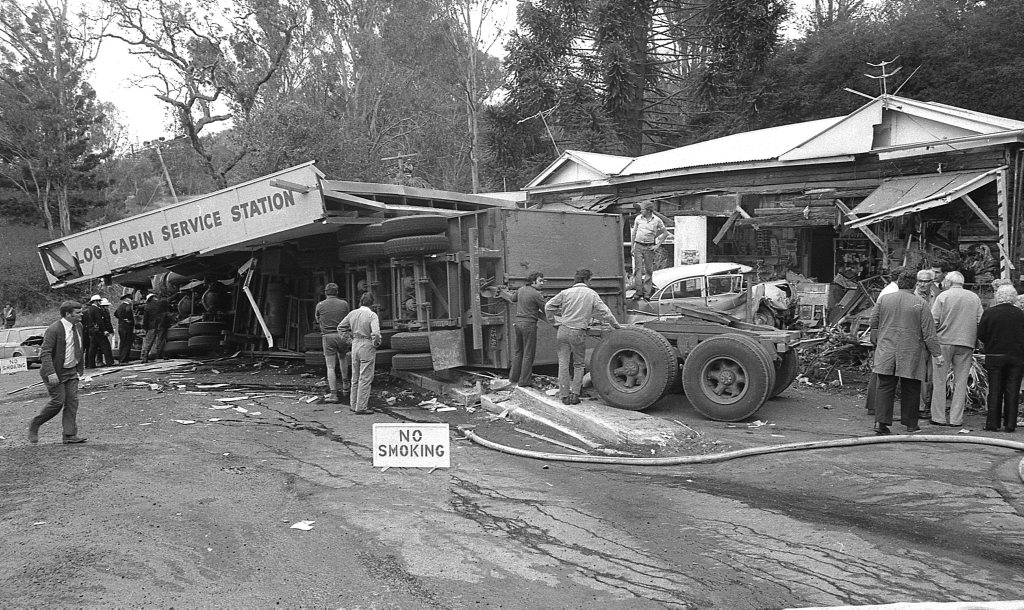 Historic: Toowooba: Accidents Semi-trailer crash at the Log Cabin Service Station on the Toowoomba Range in on 6th September,1978. Three men suffered minor injuries during the crash when the semi-trailer rolled taking out petrol bowsers. A car parked at the service station was also damaged. Photo: Bruce Mackenzie / The Chronicle Neg U869. Picture: Bruce Mackenzie