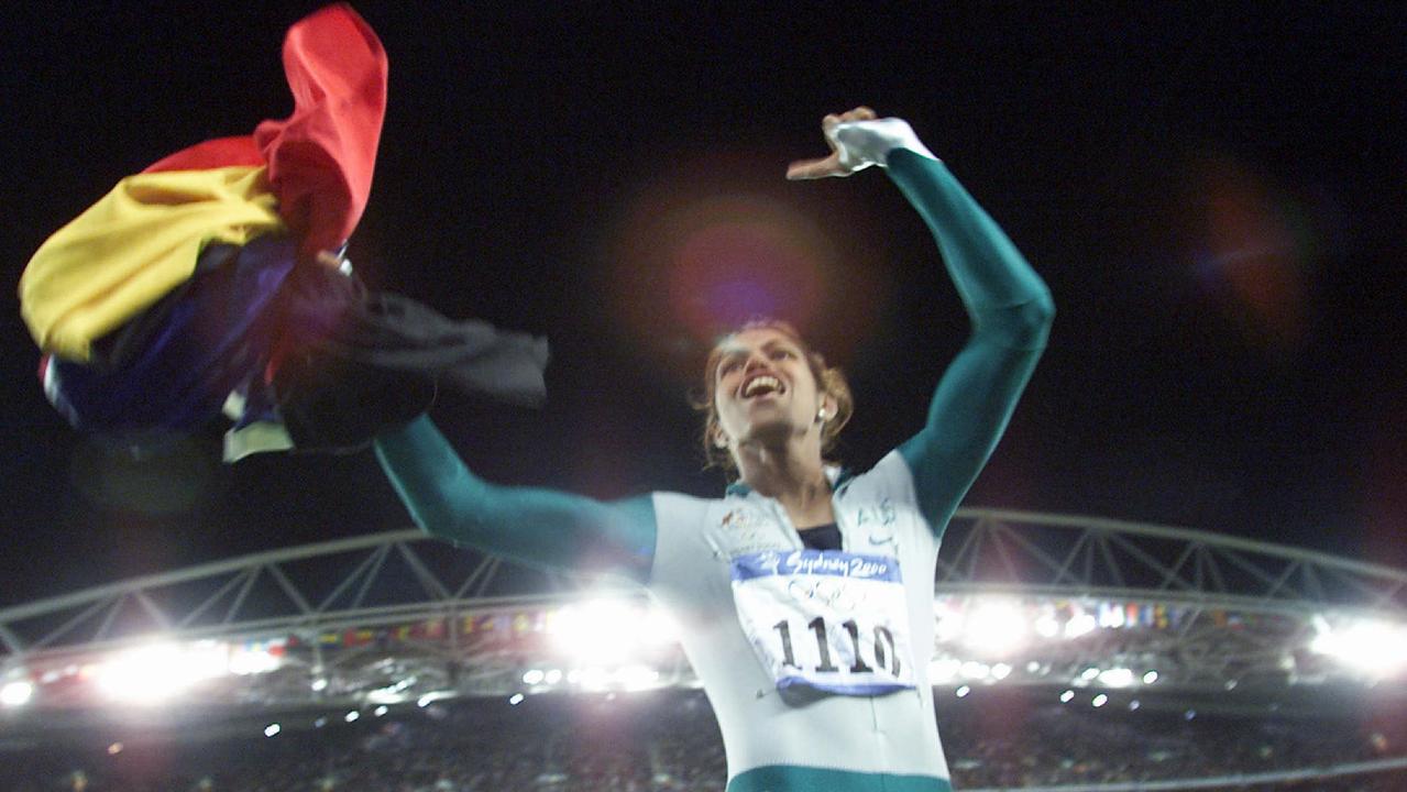 Athletics - athlete Cathy Freeman holding Aboriginal and Australian flag after winning 400m final race at Olympic Games in Sydney 25 Sep 2000.  flags