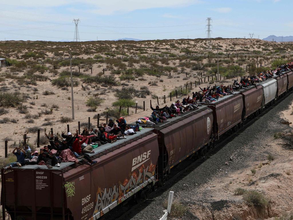 Migrants seeking asylum in the United States travel on freight cars of the Mexican train known as “The Beast” as they arrive at the border city of Ciudad Juarez, in Chihuahua state, Mexico on April 24, 2024. Picture: AFP