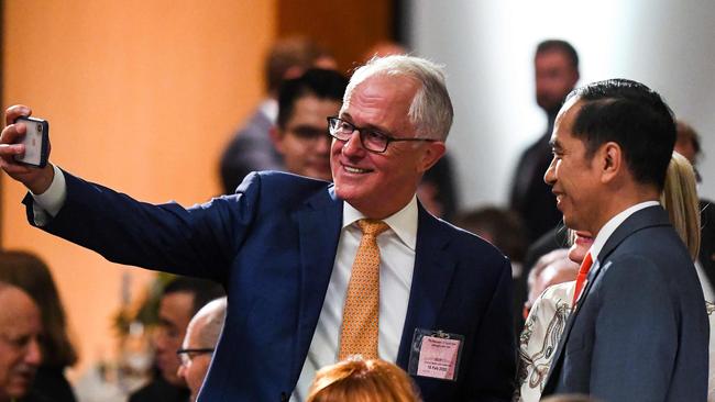 Former prime minister Malcolm Turnbull takes a selfie with Indonesia's then president Joko Widodo in 2020. Picture: Lukas Coch/Pool/AFP