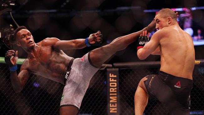 Israel Adesanya kicking Robert Whittaker during the main event of UFC 243 at Marvel Stadium. Picture: AAP Image/Michael Dodge.