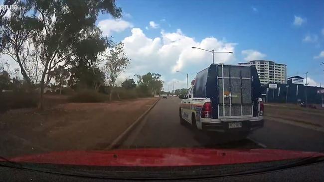 Dashcam footage has shown a police vehicle narrowly avoiding colliding with a Darwin motorist on the Stuart Hwy. Video: Brett Perry