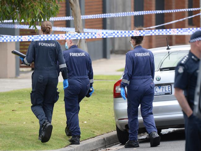 Forensic crews prepare to enter the home. Picture: Andrew Henshaw