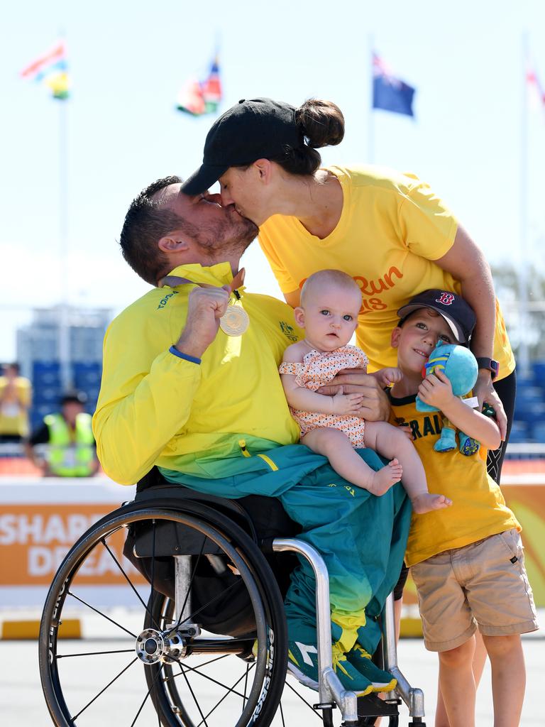 Fond memories: Gold medalist Kurt Fearnley with his wife Sheridan and children, Harry and baby Emilia, during the medal ceremony for the T54 Marathon Gold Coast Commonwealth Games, April 2018. Source: AAP