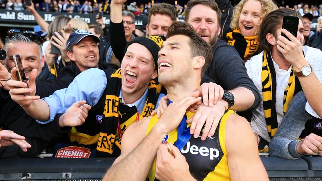 Rance celebrates the Grand Final win with fans at the MCG. Picture: Mark Stewart