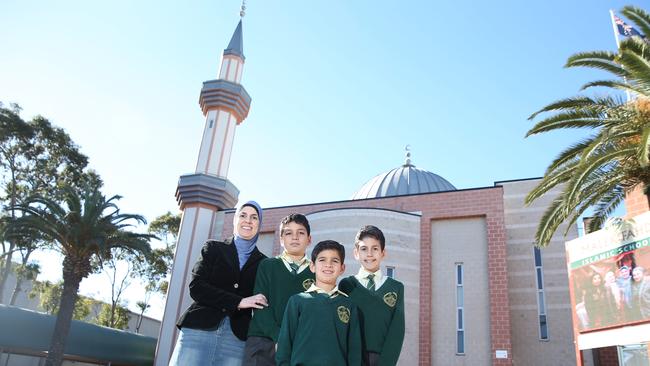 Local mother Fariha Dib with children Jamal Kak, Zakariya Kak and Jibril Kak outside of Malek Fahd Islamic School.