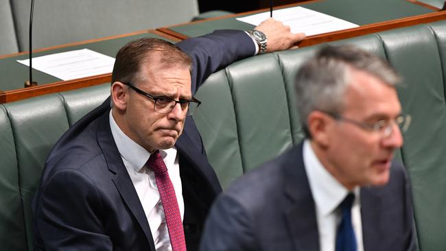 Deputy Chair of Parliamentary Joint Committee on Intelligence and Security Anthony Byrne listens to Shadow Attorney-General Mark Dreyfus in the House of Representatives at Parliament House in Canberra.