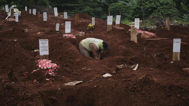 A grave digger works in a section of a municipal cemetery COVID-19 victims in Jakarta, Indonesia. Picture: Getty Images