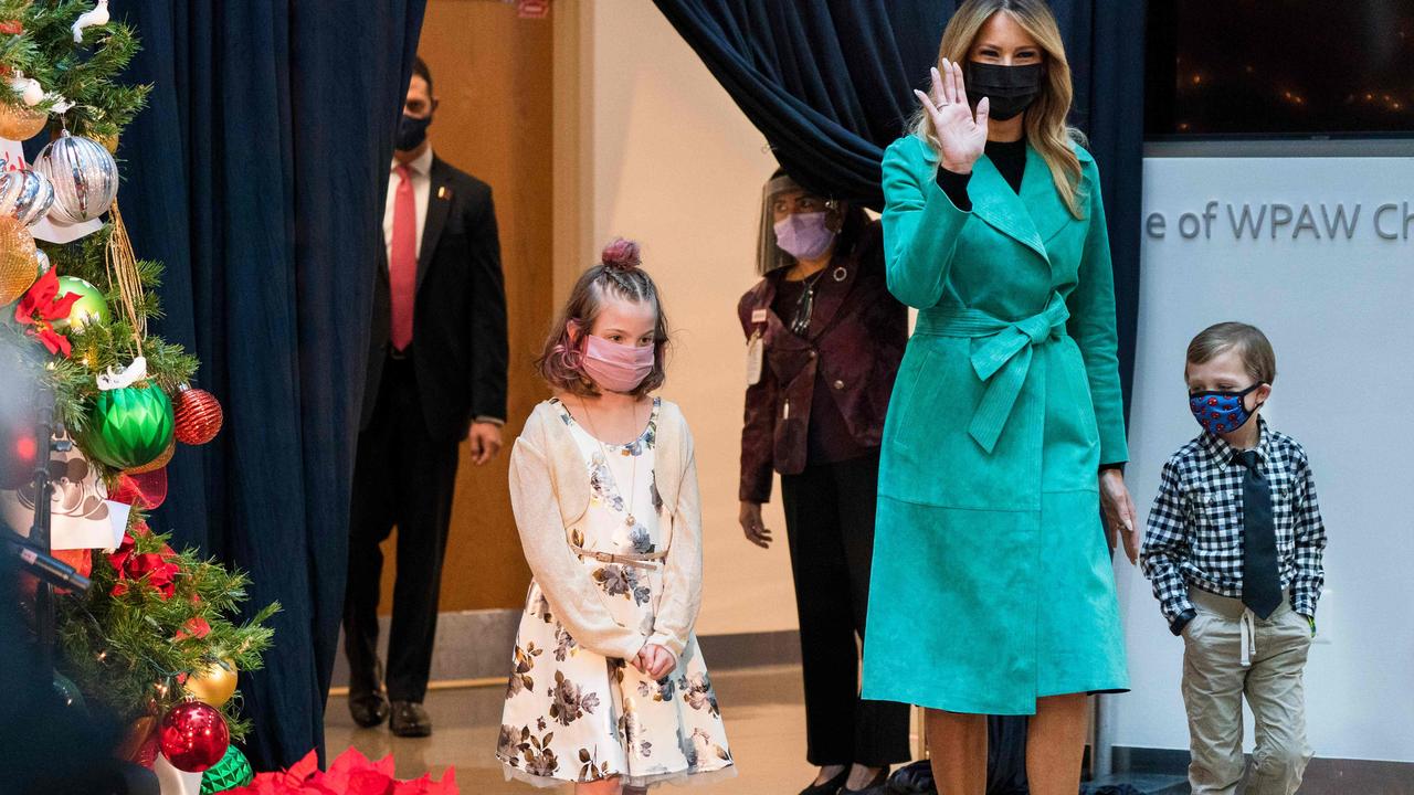 She was wearing a mask when she arrived at the hospital. She is pictured here with hospital patients Sofia Martinez, 8, (left) and Riley Whitney, 6. Picture: Jacquelyn Martin/AFP