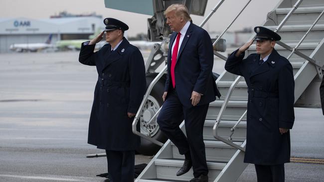 Donald Trump arrives at Miami International Airport to attend the Republican National Committee winter meetings on Friday. Picture: AP