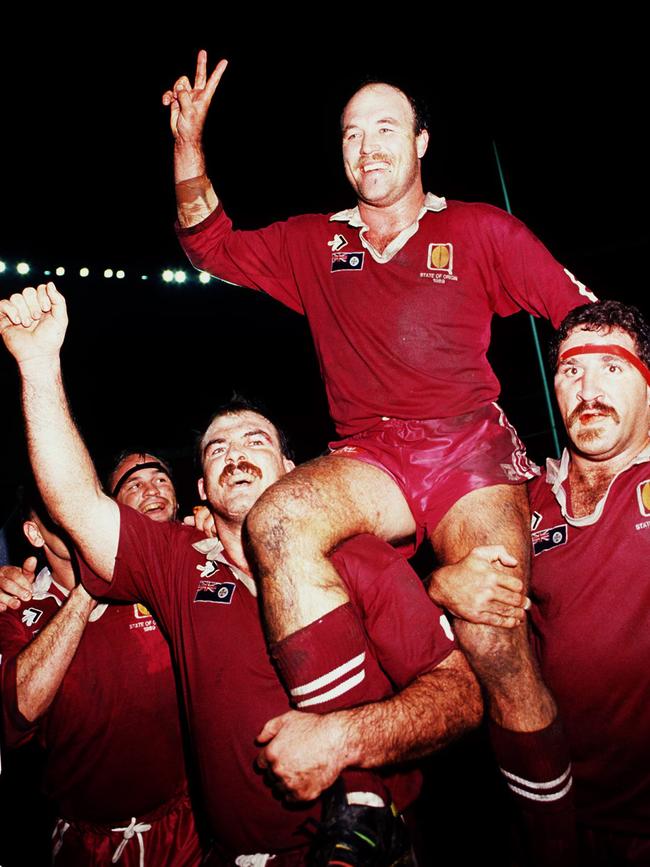 Martin Bella and Sam Backo carry Lewis around the ground after victory at Lang Park in 1991.