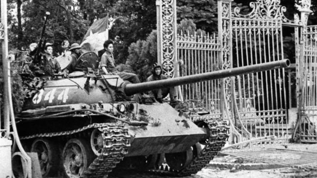 A North Vietnamese tank rolls through the gates of the Presidential Palace in Saigon in 1975. Picture: AP