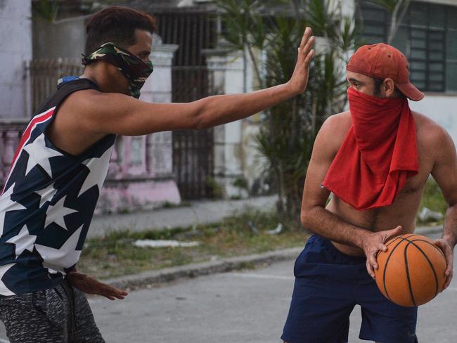 Cuban men play basketball on the street while wearing protective face masks to prevent the spread of the new coronavirus, COVID-19, in Havana. Picture: AFP