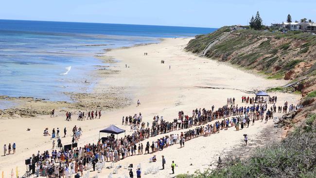 A guard of honour is formed as the pallbearers walk Khai’s coffin off the beach. Picture: Russell Millard Photography