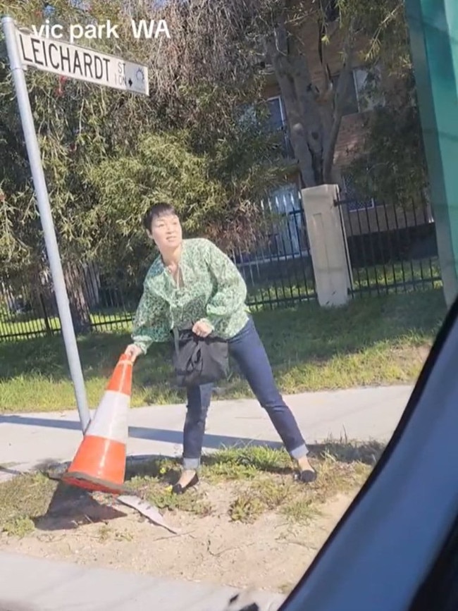 The woman picked up a traffic cone on the side of the road. Picture: TikTok