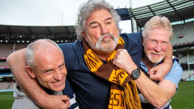 AFL greats Andrew Bews, Robert ‘Dipper’ DiPierdomenico and Neville Bruns re-enact their 1989 Grand Final brawl on the members wing at the MCG. Picture: Mark Stewart