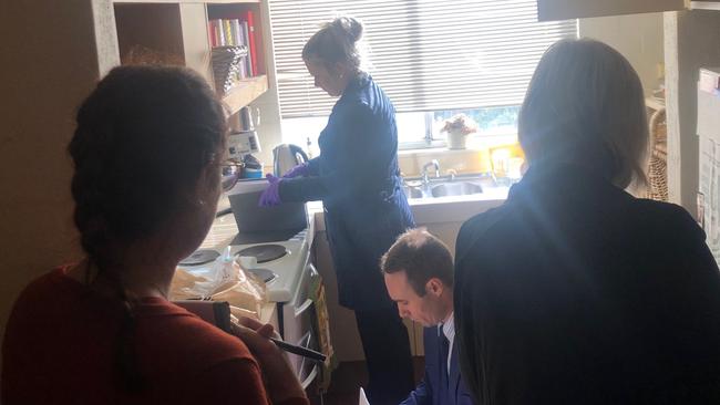 Federal police going through Annika Smethurst’s kitchen. Picture: Supplied