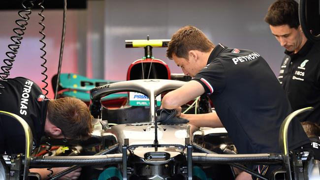 Mechanics work on the car of Mercedes' British driver Lewis Hamilton in the garage at the Albert Park. Picture: AFP