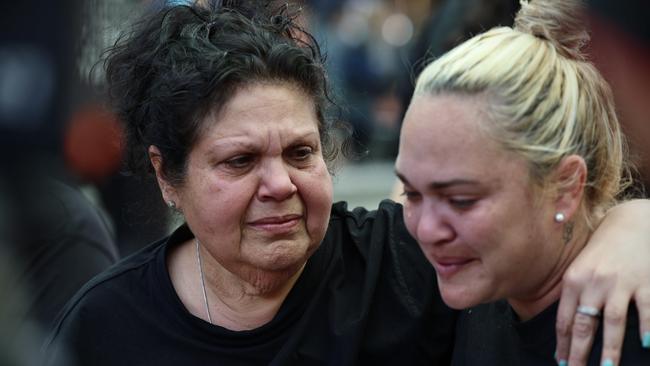 Mechelle Turvey, mother of Cassius Turvey, embraces Emily Farmer, left, at an emotional Perth rally. Picture: Getty Images