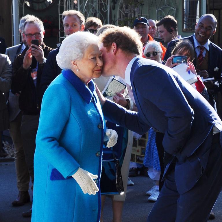 The Queen and Prince Harry sharing a special moment before exited the royal family. Picture: EPA/STUART C. WILSON.