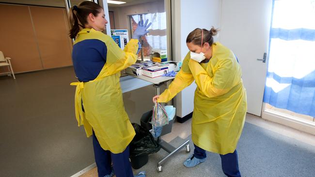 Nurses Tamzin Ingram and Skye Haagmans prepare for patients at the COVID-19 Clinic at the Mount Barker Hospital. Picture: AAP / Kelly Barnes