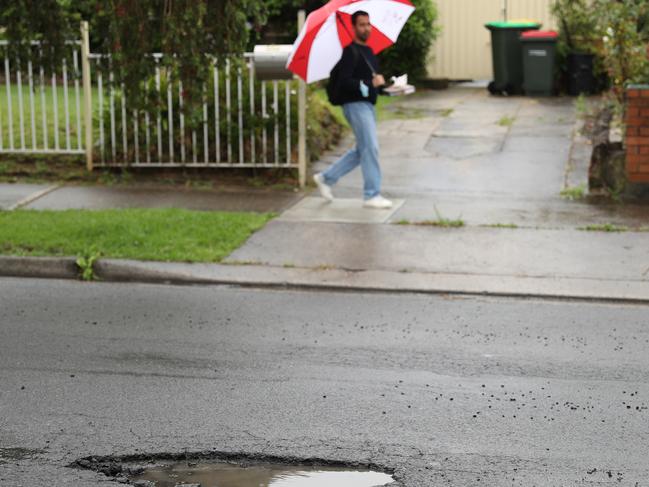 Persistent rain opened up potholes across the city. Picture: John Grainger