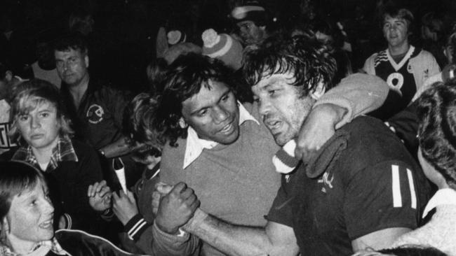 Captain Arthur Beetson surrounded by fans as he leaves field after first ever Queensland v NSW State of Origin game at Lang Park in Brisbane, 07/07/1980. Pic News Limited.