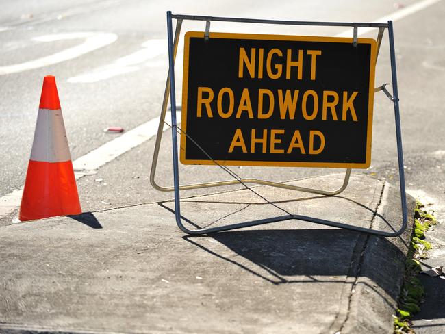 A sign warning of night roadwork ahead stands on the side of the road in Sydney on Tuesday, May 22, 2012. (AAP Image/Paul Miller) NO ARCHIVING