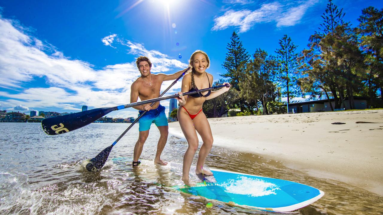 Emily Giesler from Los Angeles and Alex Kadar from Philadelphia enjoy the first Blue Sky Day for what feels like months at Budds Beach on the Gold Coast. Picture: Nigel Hallett