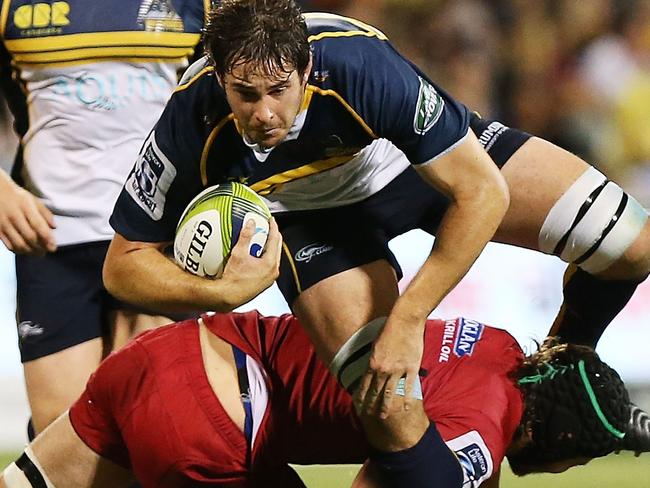 CANBERRA, AUSTRALIA - FEBRUARY 13: Sam Carter of the Brumbies is tackled during the round one Super Rugby match between the Brumbies and the Reds at GIO Stadium on February 13, 2015 in Canberra, Australia. (Photo by Stefan Postles/Getty Images)