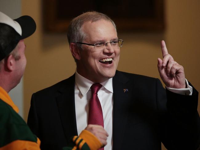 Treasurer Scott Morrison speaks with comedian Peter Helliar in the Federal Budget lockup. Picture: Stefan Postles/Getty Images)